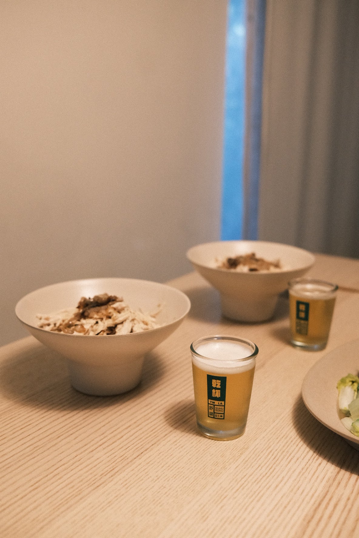 Close-up of a dinner setting of two with beer cups 