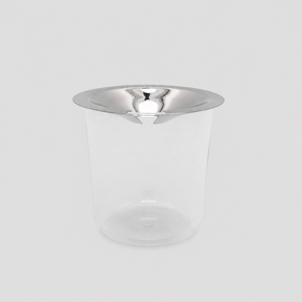 Clear glass vase with stainless steel lid on a light gray background