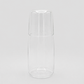 Glass water carafe on a light grey background