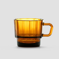 Amber glass mug on a light gray background