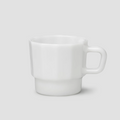 White glass cup on a light gray background